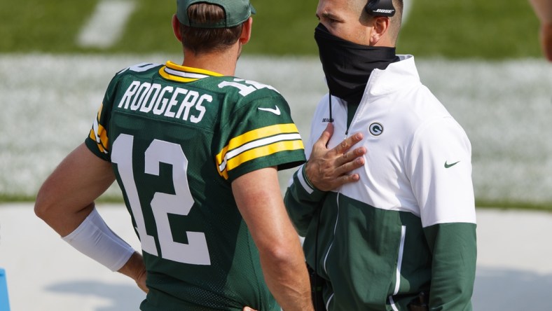 Sep 20, 2020; Green Bay, Wisconsin, USA;  Green Bay Packers quarterback Aaron Rodgers (12) talks with head coach Matt LaFleur during the third quarter of the game against the Detroit Lions at Lambeau Field. Mandatory Credit: Jeff Hanisch-USA TODAY Sports