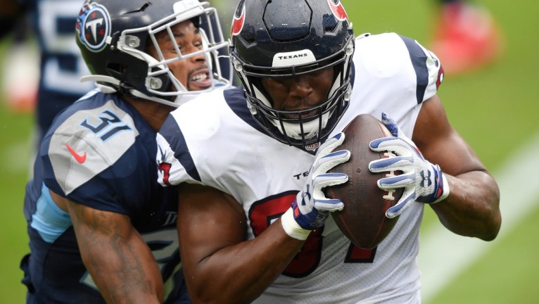 Houston Texans tight end Darren Fells (87) hauls in a touchdown pass defended by Tennessee Titans free safety Kevin Byard (31) during the second quarter at Nissan Stadium Sunday, Oct. 18, 2020 in Nashville, Tenn.

An52857