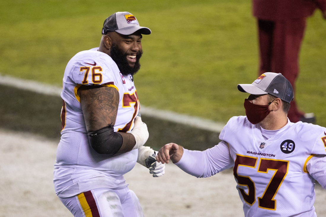 Jan 3, 2021; Philadelphia, Pennsylvania, USA; Washington Football Team offensive tackle Morgan Moses (76) and long snapper Nick Sundberg (57) celebrate after winning the NFC East championship in a game against the Philadelphia Eagles at Lincoln Financial Field. Mandatory Credit: Bill Streicher-USA TODAY Sports