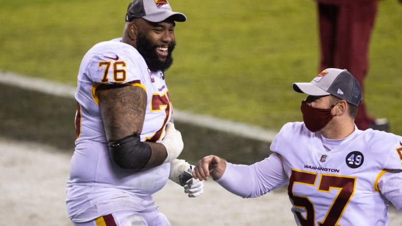 Jan 3, 2021; Philadelphia, Pennsylvania, USA; Washington Football Team offensive tackle Morgan Moses (76) and long snapper Nick Sundberg (57) celebrate after winning the NFC East championship in a game against the Philadelphia Eagles at Lincoln Financial Field. Mandatory Credit: Bill Streicher-USA TODAY Sports