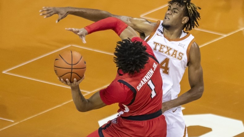 Jan 13, 2021, Austin, Texas, USA; Texas Tech Red Raiders guard Terrence Shannon Jr. (1) drives against Texas Longhorns forward Greg Brown (4) in the first half of an NCAA college basketball game on Wednesday, Jan. 13, 2021, in Austin, Texas.  Mandatory credit: Ricardo B. Brazziell /American-Statesman via USA TODAY Network