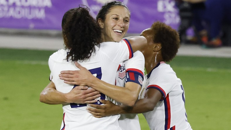 Jan 22, 2021; Orlando, Florida, USA;  United States forward Carli Lloyd (10) gets a congratulations from defender Margaret Purce (23) and midfielder Lindsey Horan (9) following her goal against Colombia during the second half at Exploria Stadium. Mandatory Credit: Reinhold Matay-USA TODAY Sports