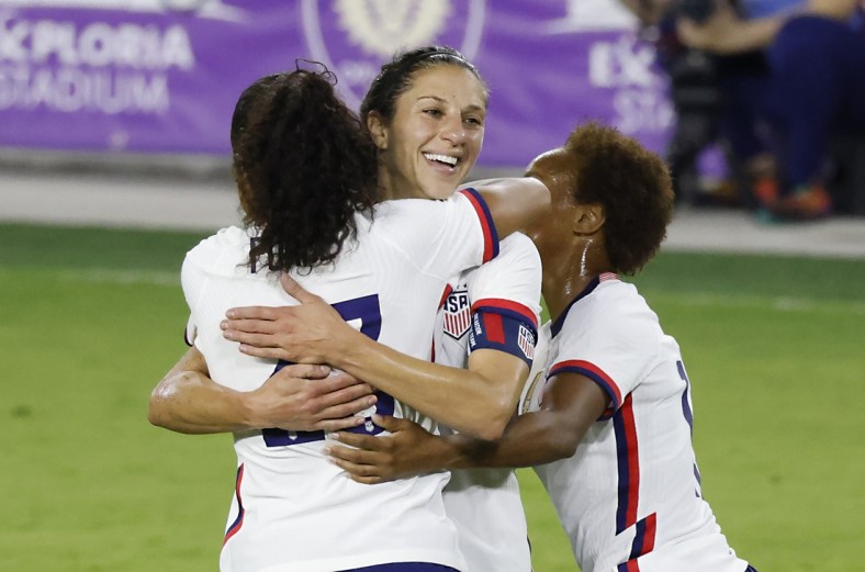 Jan 22, 2021; Orlando, Florida, USA;  United States forward Carli Lloyd (10) gets a congratulations from defender Margaret Purce (23) and midfielder Lindsey Horan (9) following her goal against Colombia during the second half at Exploria Stadium. Mandatory Credit: Reinhold Matay-USA TODAY Sports