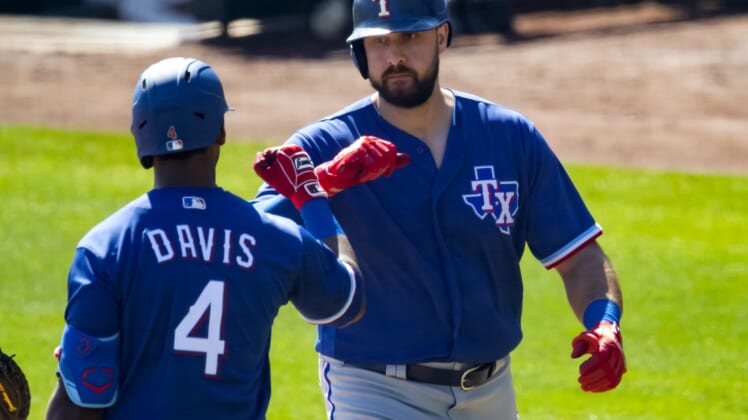 Mar 2, 2021; Phoenix, Arizona, USA; Texas Rangers designated hitter Joey Gallo celebrates with teammate Khris Davis after hitting a home run against the Chicago White Sox during a Spring Training game at Camelback Ranch Glendale. Mandatory Credit: Mark J. Rebilas-USA TODAY Sports