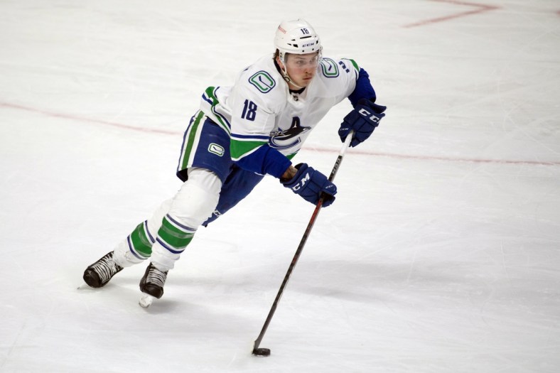 Mar 15, 2021; Ottawa, Ontario, CAN; Vancouver Canucks right wing Jake Virtanen (18) skates with the puck in the third period against the Ottawa Senators at the Canadian Tire Centre. Mandatory Credit: Marc DesRosiers-USA TODAY Sports