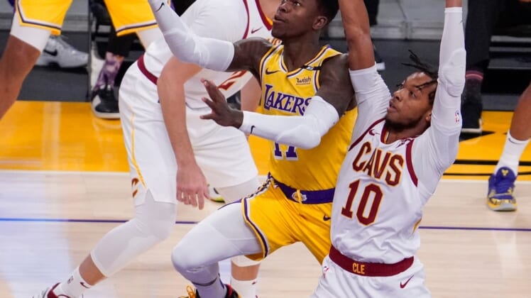 Mar 26, 2021; Los Angeles, California, USA; Los Angeles Lakers guard Dennis Schroder (17) drives to the hoop past Cleveland Cavaliers guard Darius Garland (10) during the first quarter at Staples Center. Mandatory Credit: Robert Hanashiro-USA TODAY Sports
