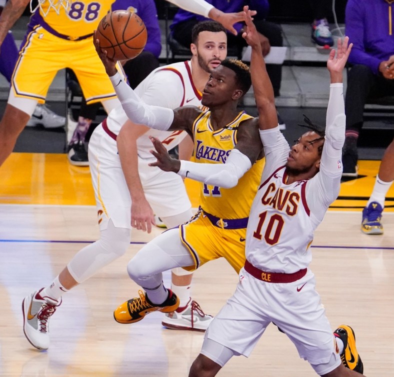 Mar 26, 2021; Los Angeles, California, USA; Los Angeles Lakers guard Dennis Schroder (17) drives to the hoop past Cleveland Cavaliers guard Darius Garland (10) during the first quarter at Staples Center. Mandatory Credit: Robert Hanashiro-USA TODAY Sports