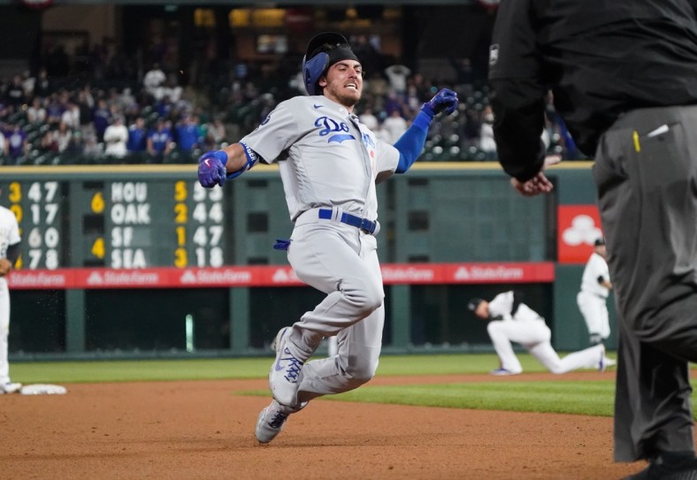 Apr 2, 2021; Denver, Colorado, USA; Los Angeles Dodgers center fielder Cody Bellinger (35) starts to slide into third for a triple in the eighth inning against the Colorado Rockies at Coors Field. Mandatory Credit: Ron Chenoy-USA TODAY Sports