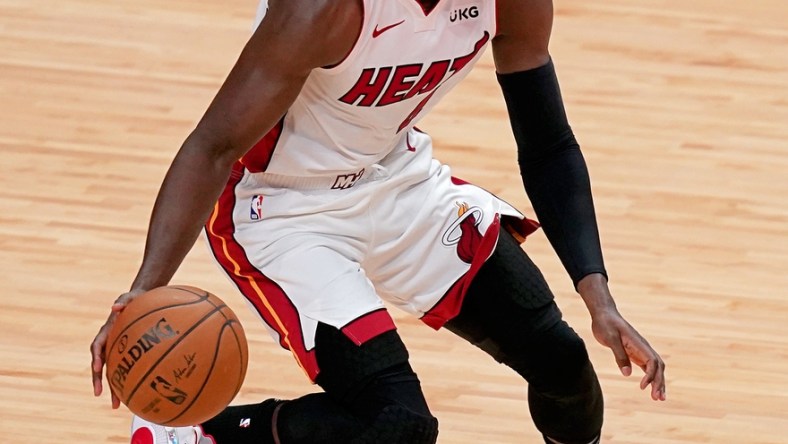 Apr 6, 2021; Miami, Florida, USA; Miami Heat guard Victor Oladipo (4) dribbles the ball up the court against the Memphis Grizzlies during the first half at American Airlines Arena. Mandatory Credit: Jasen Vinlove-USA TODAY Sports