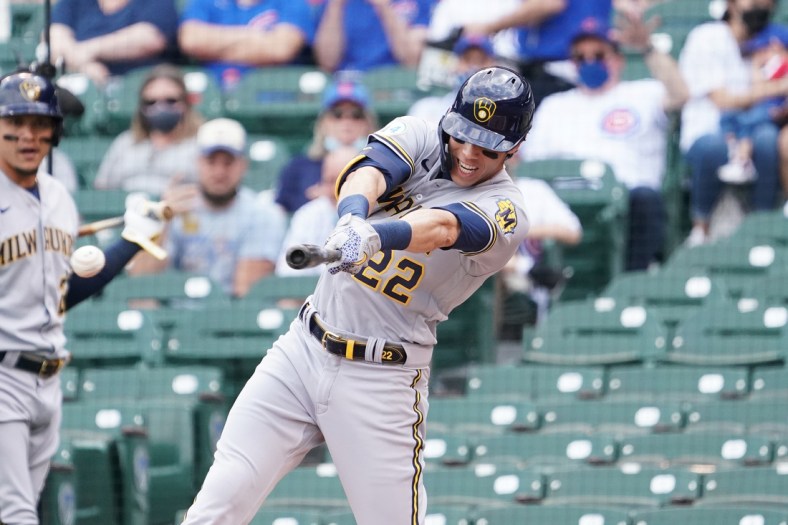 Apr 7, 2021; Chicago, Illinois, USA; Milwaukee Brewers left fielder Christian Yelich (22) hits a single against the Chicago Cubs during the first inning at Wrigley Field. Mandatory Credit: David Banks-USA TODAY Sports