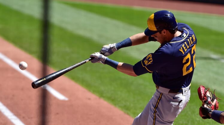Apr 11, 2021; St. Louis, Missouri, USA;  Milwaukee Brewers left fielder Christian Yelich (22) hits a single off of St. Louis Cardinals starting pitcher Daniel Ponce de Leon (not pictured) during the second inning at Busch Stadium. Mandatory Credit: Jeff Curry-USA TODAY Sports