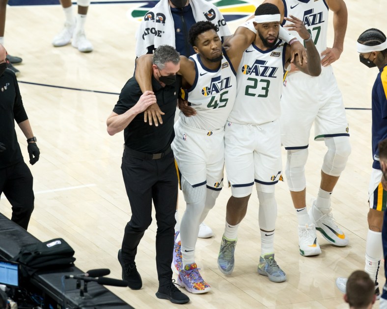 Apr 16, 2021; Salt Lake City, Utah, USA; Utah Jazz guard Donovan Mitchell (45) is helped off the court after suffering an apparent injury during the second half against the Indiana Pacers at Vivint Smart Home Arena. Mandatory Credit: Russell Isabella-USA TODAY Sports