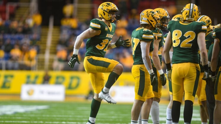 North Dakota State kicker Nathan Whiting warms up his leg during a huddle in the Dakota Marker rivalry game on Saturday, April 17, 2021, at the Fargodome in Fargo.Dakota Marker 015