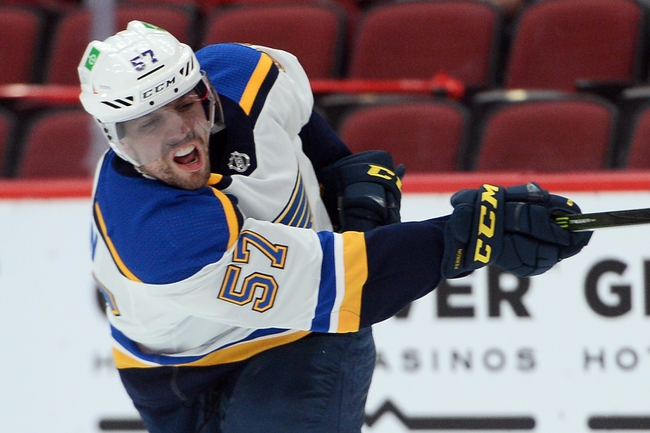 Apr 17, 2021; Glendale, Arizona, USA; St. Louis Blues left wing David Perron (57) shoots against the Arizona Coyotes during the first period at Gila River Arena. Mandatory Credit: Joe Camporeale-USA TODAY Sports
