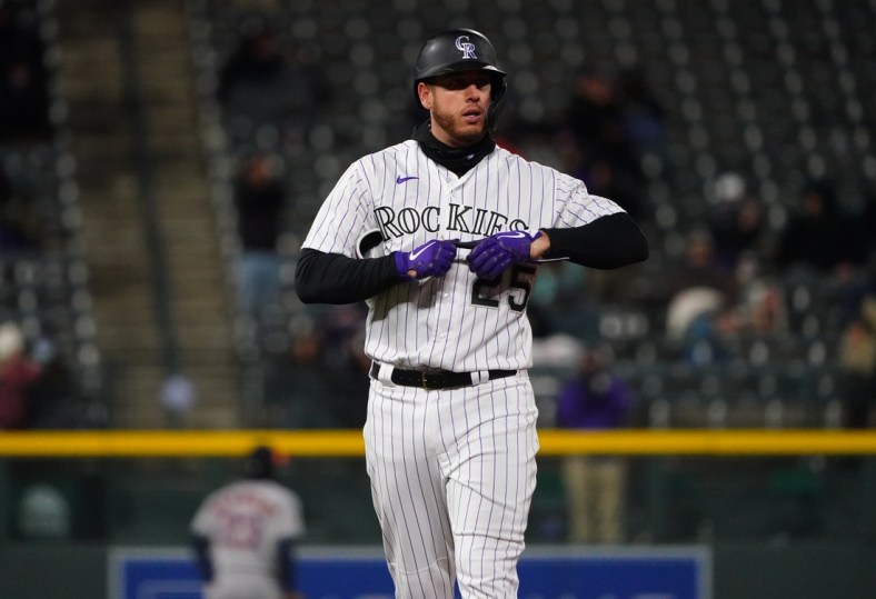 Apr 20, 2021; Denver, Colorado, USA; Colorado Rockies first baseman C.J. Cron (25) following a two run double in the sixth inning against the Houston Astros at Coors Field. Mandatory Credit: Ron Chenoy-USA TODAY Sports
