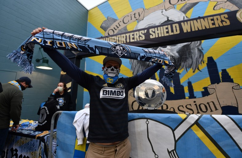 Apr 24, 2021; Philadelphia, Pennsylvania, USA; A fan poses in front of the Supports' Shield Trophy before the game between Inter Miami CF and the Philadelphia Union at Talen Energy Stadium. Mandatory Credit: Kyle Ross-USA TODAY Sports