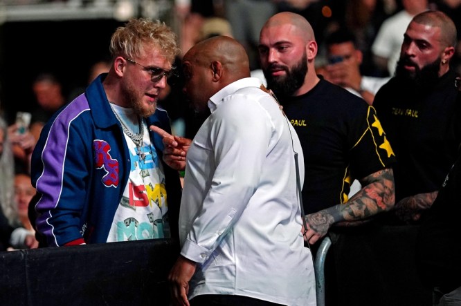 Apr 24, 2021; Jacksonville, Florida, USA; YouTube star Jake Paul is confronted by UFC ringside announcer Daniel Cormier before Anthony Smith (Red Gloves) fights Jimmy Crute (Blue Gloves) during UFC 261 at VyStar Veterans Memorial Arena. Mandatory Credit: Jasen Vinlove-USA TODAY Sports