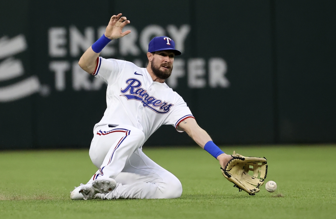 Apr 26, 2021; Arlington, Texas, USA; Texas Rangers left fielder David Dahl (21) cannot make a catch during the second inning against the Los Angeles Angels at Globe Life Field. Mandatory Credit: Kevin Jairaj-USA TODAY Sports