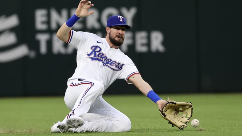 Apr 26, 2021; Arlington, Texas, USA; Texas Rangers left fielder David Dahl (21) cannot make a catch during the second inning against the Los Angeles Angels at Globe Life Field. Mandatory Credit: Kevin Jairaj-USA TODAY Sports