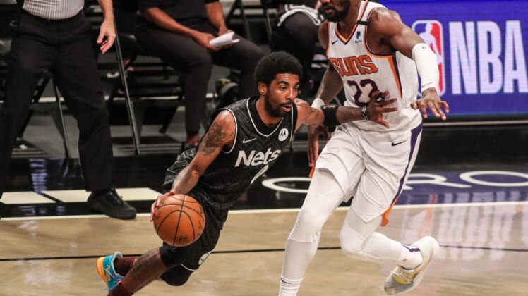 Apr 25, 2021; Brooklyn, New York, USA;  Brooklyn Nets guard Kyrie Irving (11) and Phoenix Suns center Deandre Ayton (22) at Barclays Center. Mandatory Credit: Wendell Cruz-USA TODAY Sports