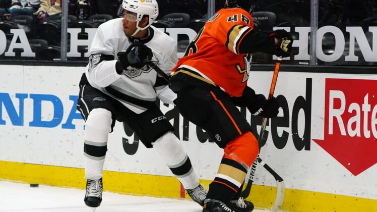 Apr 30, 2021; Anaheim, California, USA; Los Angeles Kings center Quinton Byfield (55) plays for the puck against Anaheim Ducks center Isac Lundestrom (48) during the first period at Honda Center. Mandatory Credit: Gary A. Vasquez-USA TODAY Sports