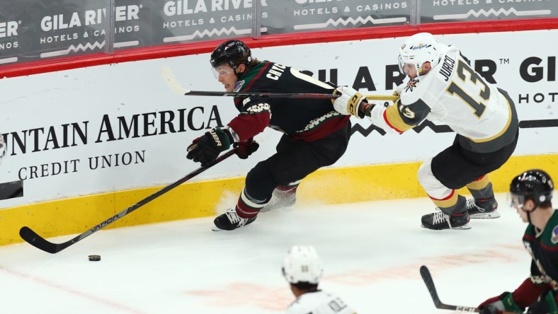 Apr 30, 2021; Glendale, Arizona, USA; Arizona Coyotes defenseman Jakob Chychrun (6) skates with the puck against Vegas Golden Knights right winger Tomas Jurco (13) in the first period at Gila River Arena. Mandatory Credit: Billy Hardiman-USA TODAY Sports