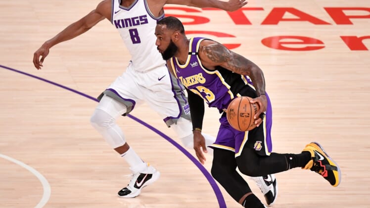 Apr 30, 2021; Los Angeles, California, USA; Los Angeles Lakers forward LeBron James (23) dribbles past Sacramento Kings forward Maurice Harkless (8) during the first quarter at Staples Center. James returned to the Lakers lineup after recovering from an ankle injury. Mandatory Credit: Robert Hanashiro-USA TODAY Sports