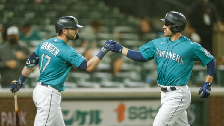 Apr 30, 2021; Seattle, Washington, USA; Seattle Mariners designated hitter Tom Murphy (2) bumps fists with right fielder Mitch Haniger (17) after digging a solo-home run against the Los Angeles Angels during the fourth inning at T-Mobile Park. Mandatory Credit: Joe Nicholson-USA TODAY Sports