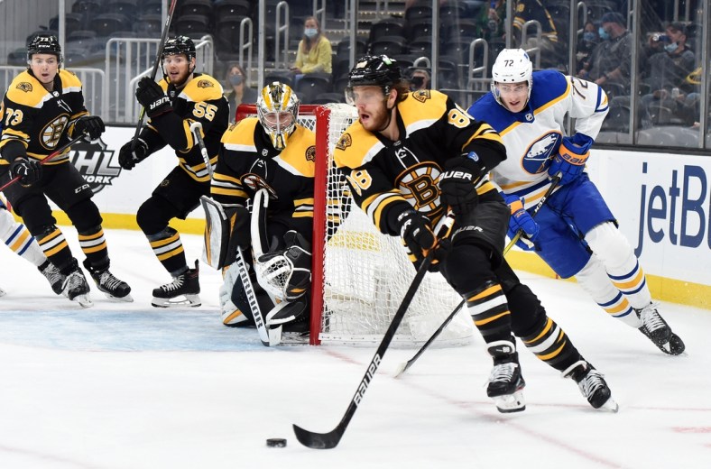 May 1, 2021; Boston, Massachusetts, USA; Boston Bruins right wing David Pastrnak (88) skates with the puck while Buffalo Sabres right wing Tage Thompson (72) gives chase during the first period at TD Garden. Mandatory Credit: Bob DeChiara-USA TODAY Sports