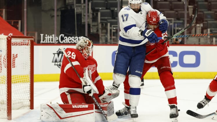 May 1, 2021; Detroit, Michigan, USA;  Tampa Bay Lightning left wing Alex Killorn (17) and Detroit Red Wings defenseman Danny DeKeyser (65) fight for position with in front of Detroit Red Wings goaltender Thomas Greiss (29) in the first period at Little Caesars Arena. Mandatory Credit: Rick Osentoski-USA TODAY Sports
