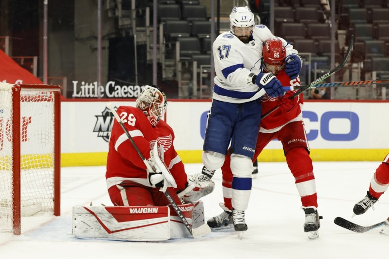 May 1, 2021; Detroit, Michigan, USA;  Tampa Bay Lightning left wing Alex Killorn (17) and Detroit Red Wings defenseman Danny DeKeyser (65) fight for position with in front of Detroit Red Wings goaltender Thomas Greiss (29) in the first period at Little Caesars Arena. Mandatory Credit: Rick Osentoski-USA TODAY Sports