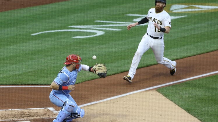 May 1, 2021; Pittsburgh, Pennsylvania, USA;  St. Louis Cardinals catcher Andrew Knizner (7) can not handle a throw from left fielder Tyler O'Neill (not pictured) allowing Pittsburgh Pirates first baseman Colin Moran (19) to score a run during the second inning at PNC Park. Mandatory Credit: Charles LeClaire-USA TODAY Sports