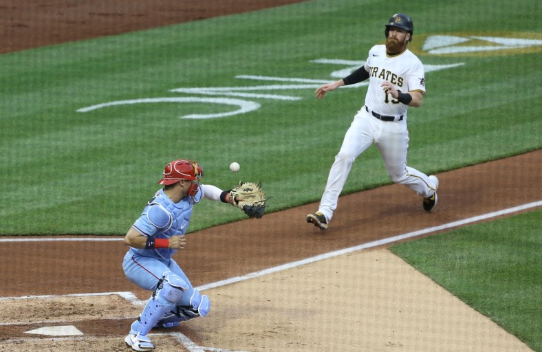 May 1, 2021; Pittsburgh, Pennsylvania, USA;  St. Louis Cardinals catcher Andrew Knizner (7) can not handle a throw from left fielder Tyler O'Neill (not pictured) allowing Pittsburgh Pirates first baseman Colin Moran (19) to score a run during the second inning at PNC Park. Mandatory Credit: Charles LeClaire-USA TODAY Sports