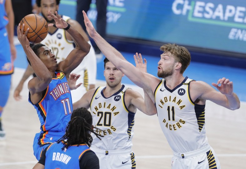 May 1, 2021; Oklahoma City, Oklahoma, USA; Oklahoma City Thunder guard Theo Maledon (11) shoots as Indiana Pacers forward Domantas Sabonis (11) defends the shot during the second quarter at Chesapeake Energy Arena. Mandatory Credit: Alonzo Adams-USA TODAY Sports