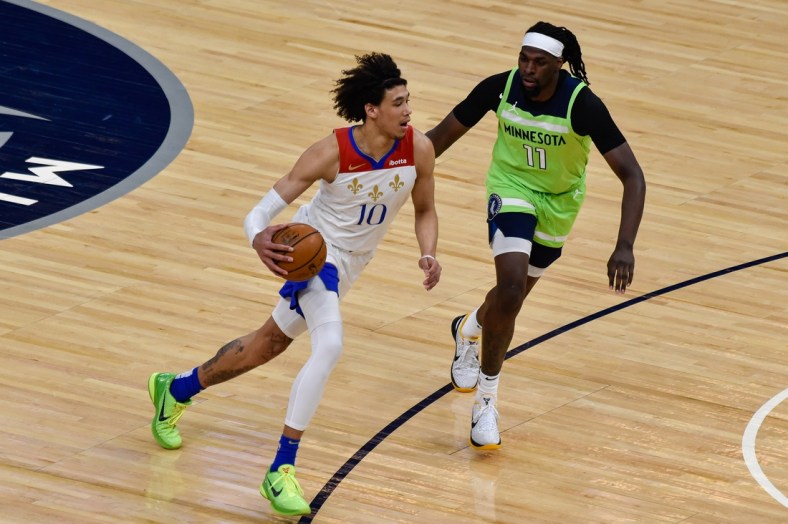 May 1, 2021; Minneapolis, Minnesota, USA; New Orleans Pelicans center Jaxson Hayes (10) controls the ball as Minnesota Timberwolves center Naz Reid (11) defends during the first quarter at Target Center. Mandatory Credit: Jeffrey Becker-USA TODAY Sports