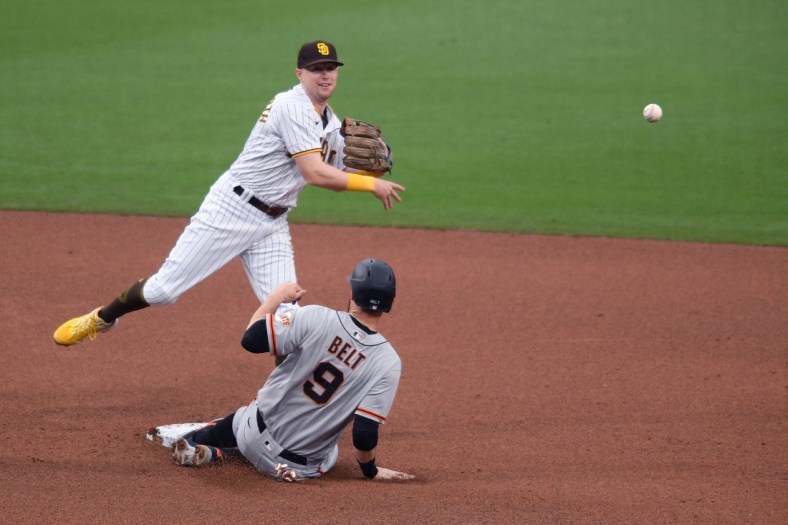 May 1, 2021; San Diego, California, USA; San Diego Padres second baseman Jake Cronenworth (L) forces out San Francisco Giants first baseman Brandon Belt (9) at second base before throwing to first base to compete the double play during the fourth inning at Petco Park. Mandatory Credit: Orlando Ramirez-USA TODAY Sports