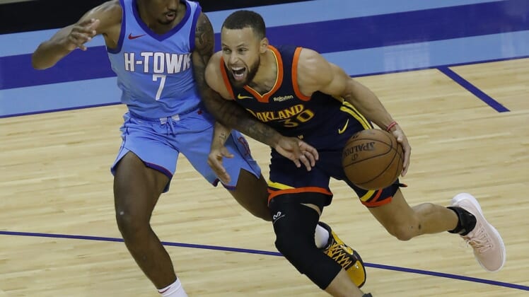 May 1, 2021; Houston, Texas, USA; Golden State Warriors guard Stephen Curry (30) drives against Houston Rockets guard Armoni Brooks (7) during the second quarter at Toyota Center. Mandatory Credit:  Bob Levey /POOL PHOTOS-USA TODAY Sports