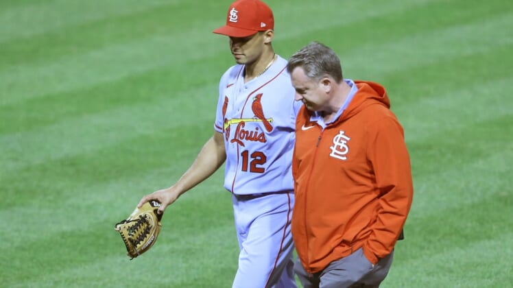 May 1, 2021; Pittsburgh, Pennsylvania, USA;  St. Louis Cardinals relief pitcher Jordan Hicks (12) leaves the field with a team trainer after suffering an apparent injury pitching against the Pittsburgh Pirates during the seventh inning at PNC Park. The Cardinals won 12-5. Mandatory Credit: Charles LeClaire-USA TODAY Sports