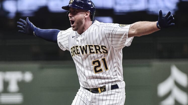May 1, 2021; Milwaukee, Wisconsin, USA;  Milwaukee Brewers third baseman Travis Shaw (21) reacts after driving in the winning run with a base hit in the eleventh inning against the Los Angeles Dodgers at American Family Field. Mandatory Credit: Benny Sieu-USA TODAY Sports