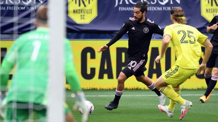 May 2, 2021; Nashville, TN, USA; Inter Miami midfielder Rodolfo Pizarro (10) plays the ball in the box as he is defended by Nashville SC defender Walker Zimmerman (25) during the first half at Nissan Stadium. Mandatory Credit: Christopher Hanewinckel-USA TODAY Sports