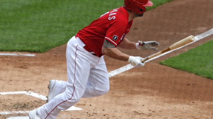 May 2, 2021; Cincinnati, Ohio, USA; Cincinnati Reds third  baseman Mike Moustakas (9) runs after hitting into a double play scoring a run against the Chicago Cubs during the first inning at Great American Ball Park. Mandatory Credit: David Kohl-USA TODAY Sports