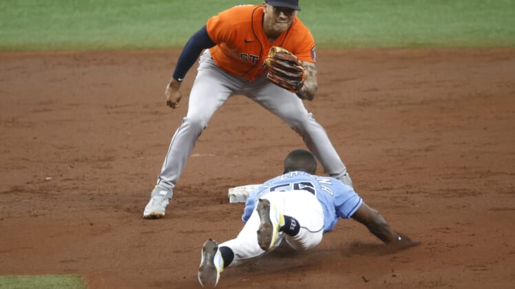 May 2, 2021; St. Petersburg, Florida, USA; Tampa Bay Rays left fielder Randy Arozarena (56) slides safely into second base as he steals and Houston Astros shortstop Carlos Correa (1) attempted to tag him out during the third inning  at Tropicana Field. Mandatory Credit: Kim Klement-USA TODAY Sports