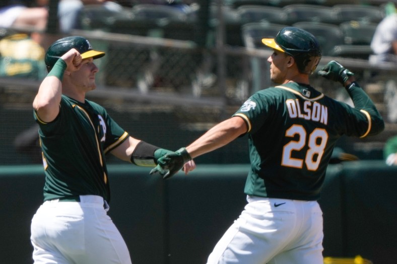 May 2, 2021; Oakland, California, USA;  Oakland Athletics catcher Sean Murphy (12) celebrates with first baseman Matt Olson (28) after scoring against the Baltimore Orioles during the third inning at RingCentral Coliseum. Mandatory Credit: Stan Szeto-USA TODAY Sports