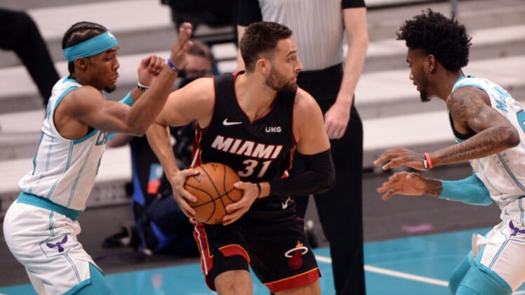 May 2, 2021; Charlotte, North Carolina, USA;  Miami Heat guard Max Strus (31) looks to pass as he is defended by Charlotte Hornets guard Devonte  Graham (4) and forward Jalen McDaniels (4) during the first half at the Spectrum Center. Mandatory Credit: Sam Sharpe-USA TODAY Sports