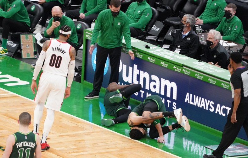 May 2, 2021; Boston, Massachusetts, USA; Boston Celtics forward Jayson Tatum (0) and guard Jaylen Brown (7) fall to the ground as head coach Brad Stevens looks on as they take on the Portland Trail Blazers in the fourth quarter at TD Garden. Mandatory Credit: David Butler II-USA TODAY Sports