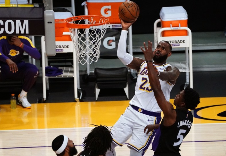 May 2, 2021; Los Angeles, California, USA; Los Angeles Lakers forward LeBron James (23) shoots against Toronto Raptors forward Stanley Johnson (5) during the first half at Staples Center. Mandatory Credit: Gary A. Vasquez-USA TODAY Sports