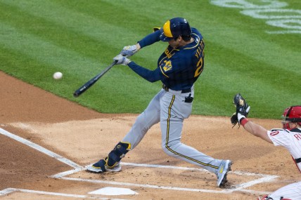 May 3, 2021; Philadelphia, Pennsylvania, USA; Milwaukee Brewers left fielder Christian Yelich (22) hits a single during the first inning against the Philadelphia Phillies at Citizens Bank Park. Mandatory Credit: Bill Streicher-USA TODAY Sports