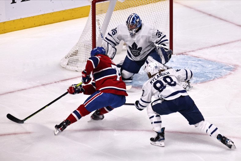May 3, 2021; Montreal, Quebec, CAN; Montreal Canadiens right wing Tyler Toffoli (73) shoots the puck against Toronto Maple Leafs goaltender Jack Campbell (36) as center William Nylander (88) defends during the first period at Bell Centre. Mandatory Credit: Jean-Yves Ahern-USA TODAY Sports