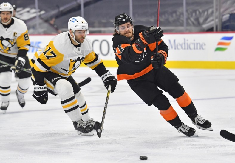 May 3, 2021; Philadelphia, Pennsylvania, USA;  Philadelphia Flyers right wing Travis Konecny (11) skates past Pittsburgh Penguins right wing Bryan Rust (17) during the first period at Wells Fargo Center. Mandatory Credit: Eric Hartline-USA TODAY Sports