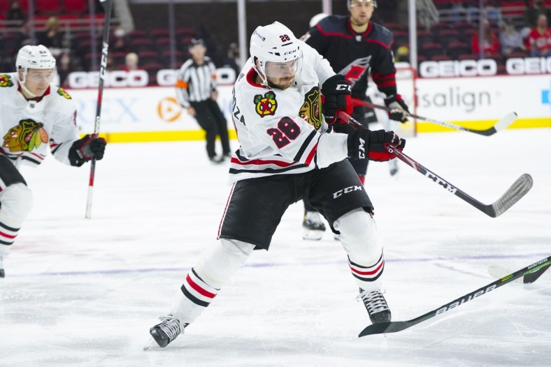 May 3, 2021; Raleigh, North Carolina, USA;  Chicago Blackhawks left wing Vinnie Hinostroza (28) takes a shot during the second period against the Carolina Hurricanes at PNC Arena. Mandatory Credit: James Guillory-USA TODAY Sports